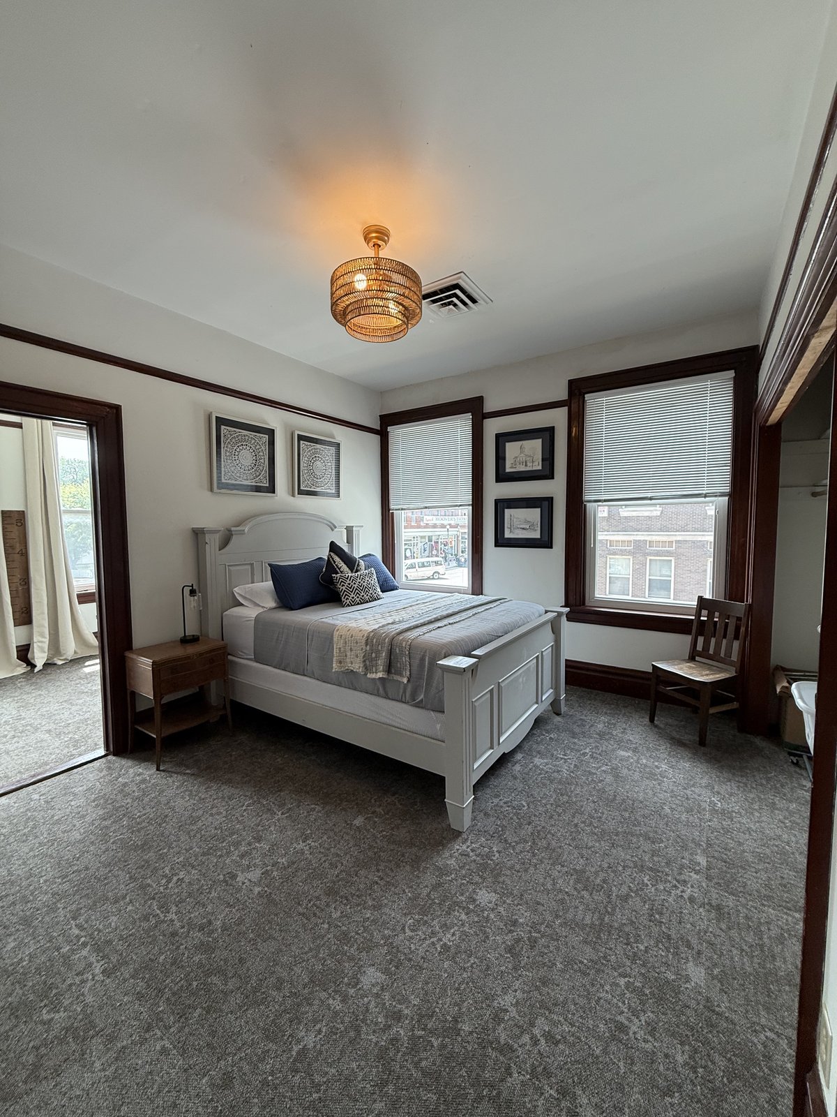 Bedroom 2 — wide view with ceiling fan and wood trim windows