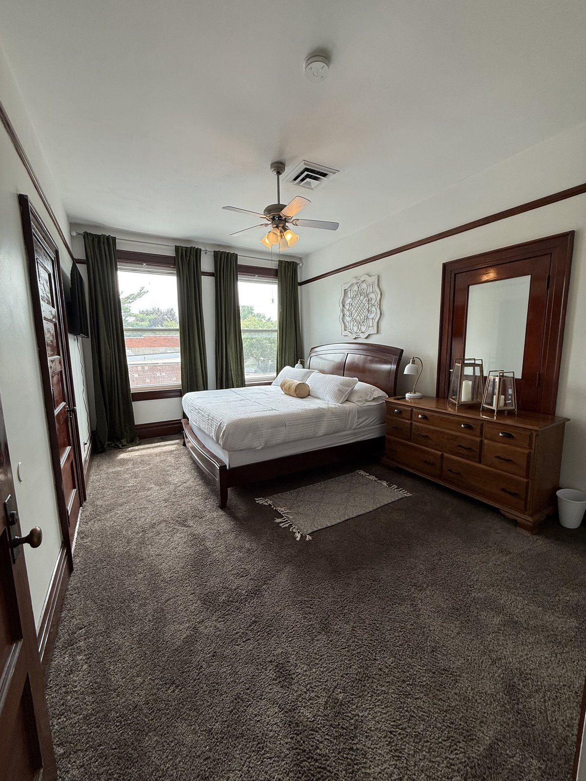 Master bedroom — sitting area with armchairs and gallery wall