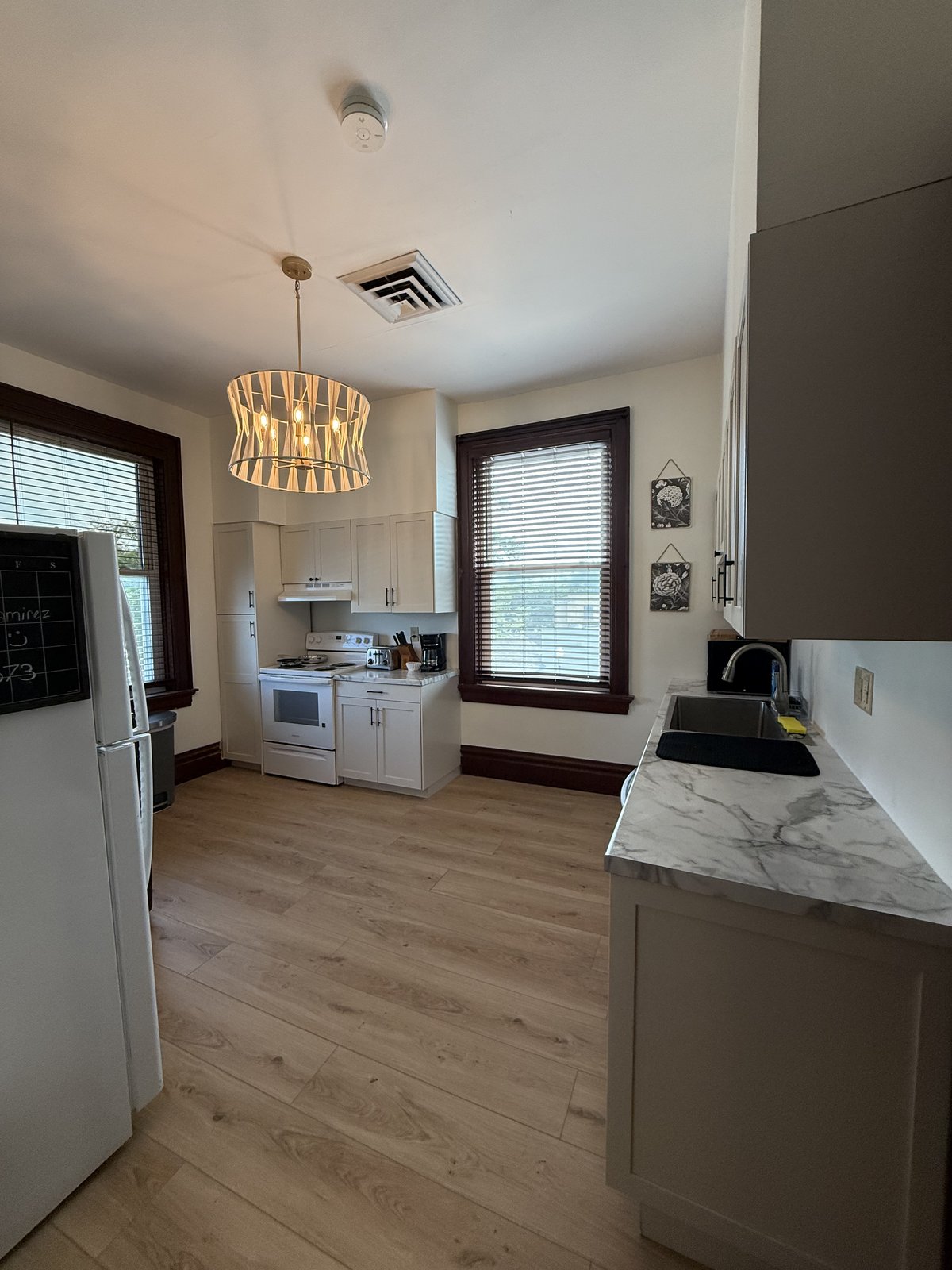 Kitchen with laundry area — white cabinets and appliances